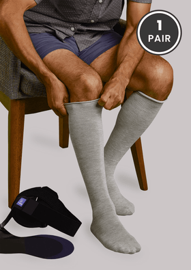 Man putting on Grey SmartKnit Seamless AFO Interface Socks for Adults