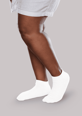 Woman wearing white SmartKnitACTIVE Active Seamless Running Socks